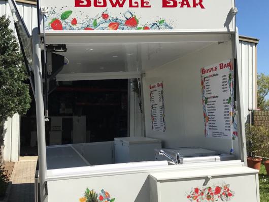 Weißer Verkaufsanhänger einer Bowle Bar mit geöffnetem Tresen im Freien