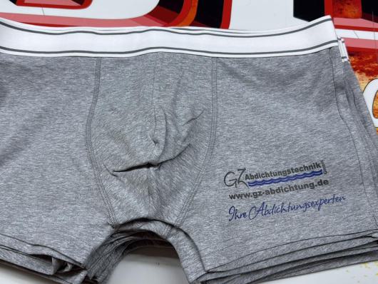 Graue Herren-Boxershorts mit weißem Bund und aufgedrucktem Firmenlogo.